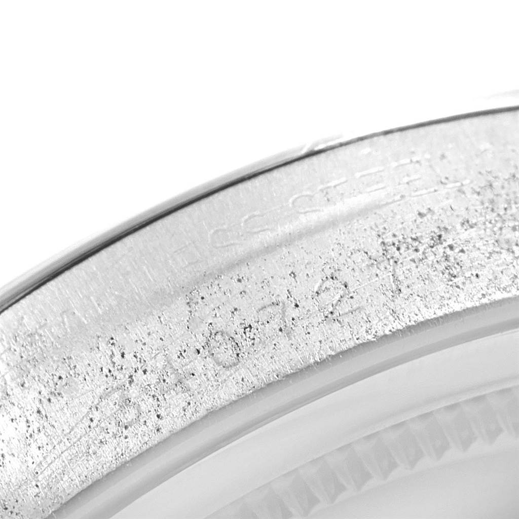 The image shows a close-up of the engraved serial number and part of the bezel of the Rolex Vintage Collection 6694 Men
s Stainless Steel Black Dial 6694 Men
s Stainless Steel Black Dial watch.