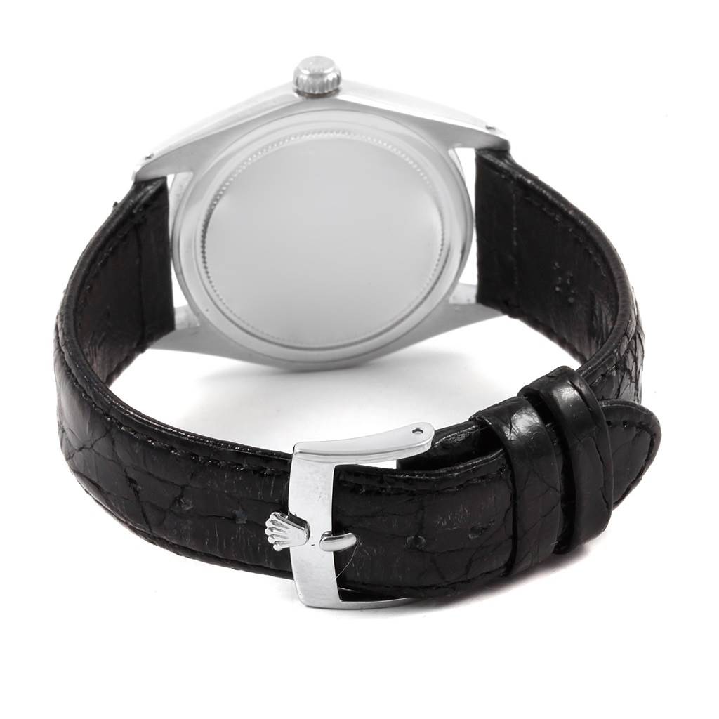 The image shows the back view of a Vintage Collection Rolex watch, highlighting the case back and black leather strap with a buckle.