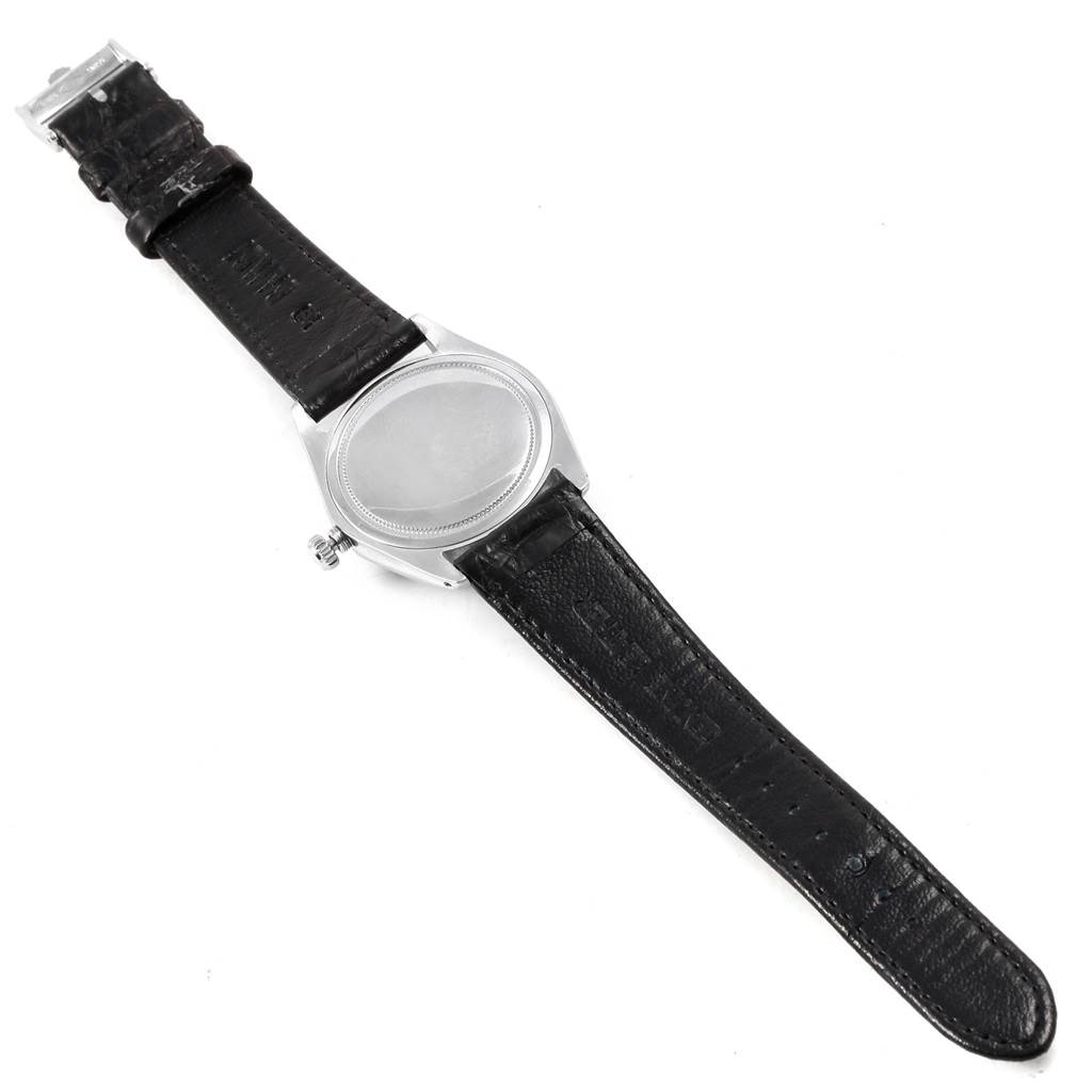 This Rolex Vintage Collection 6694 Men
s Stainless Steel Black Dial 6694 Men
s Stainless Steel Black Dial watch is shown from a top-down angle, highlighting the black leather strap and case.