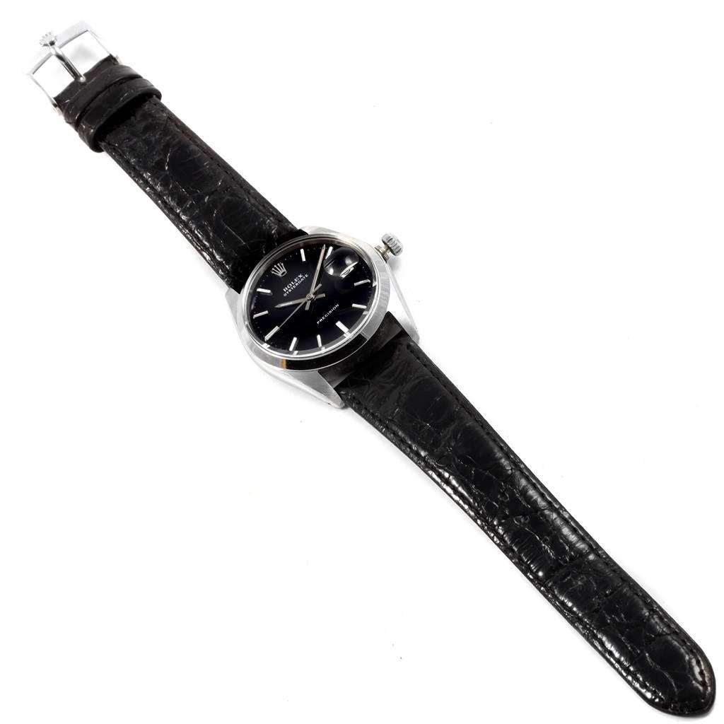 The Rolex Vintage Collection 6694 Men
s Stainless Steel Black Dial 6694 Men
s Stainless Steel Black Dial model watch is shown from a top-down angle, displaying the entire watch and leather strap.