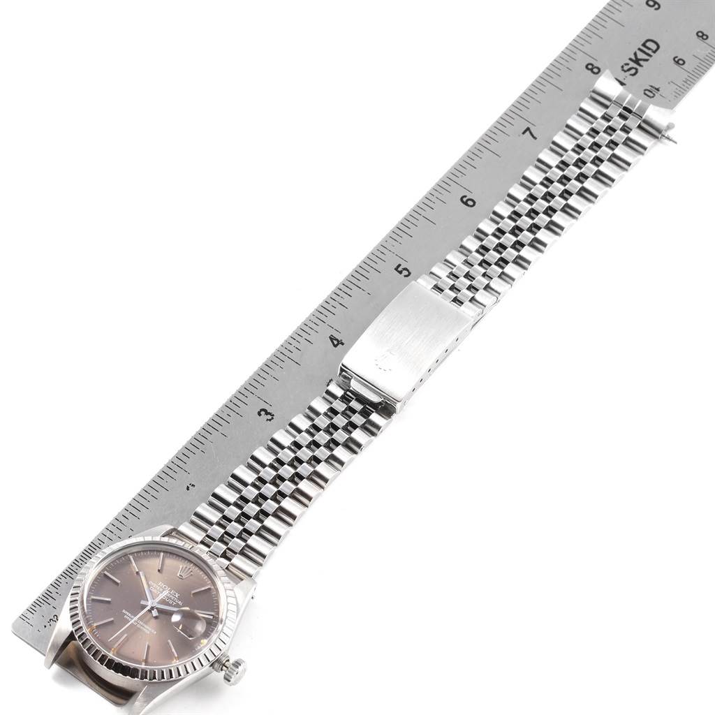 The Rolex Vintage Collection 16030 Men's Stainless Steel Brown Dial 16030 Men's Stainless Steel Brown Dial watch is shown with its face and full metal strap, laid alongside a ruler for measurement.