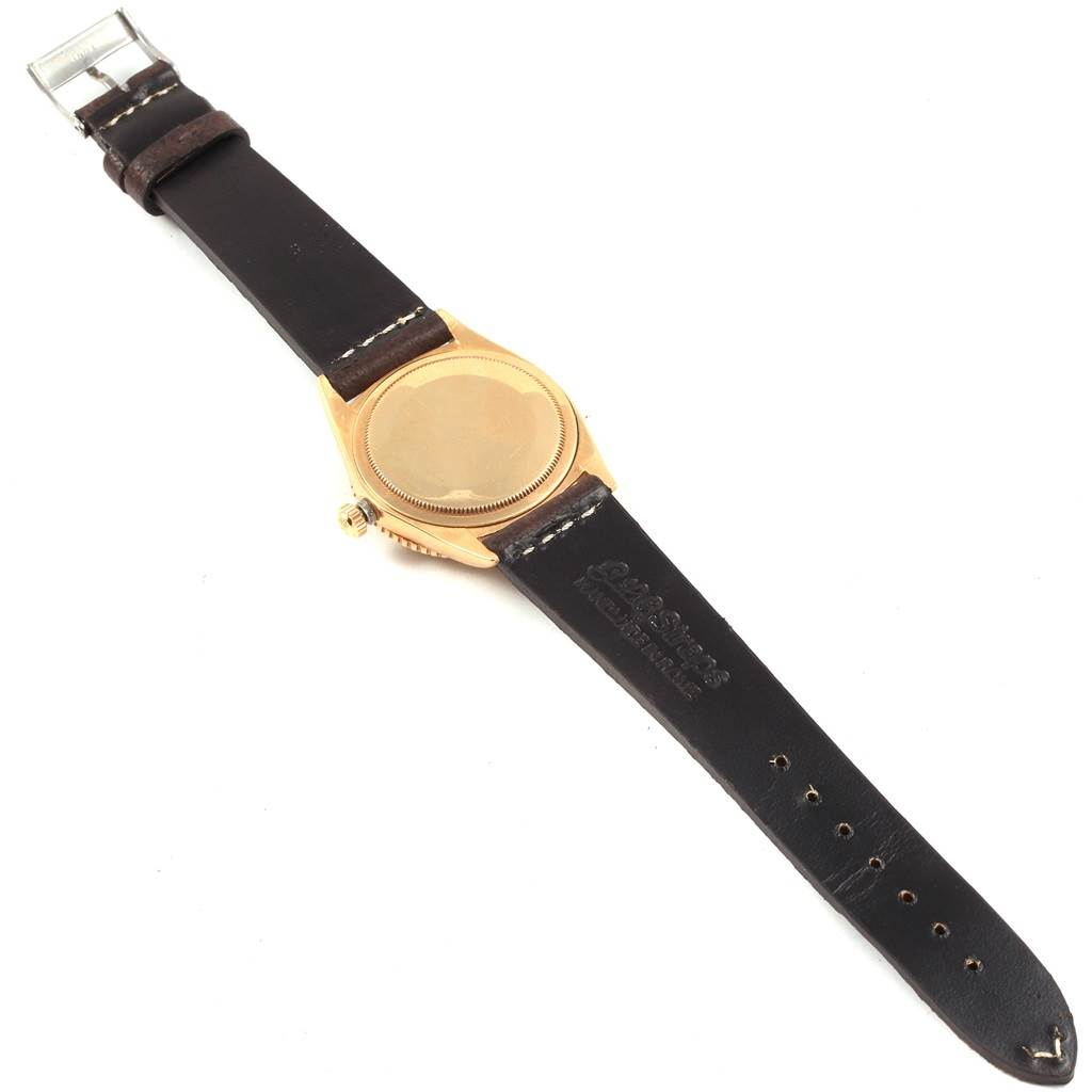 The image shows the back and strap of a Rolex Vintage Collection 1625 Men's Yellow Gold Champagne Dial 1625 Men's Yellow Gold Champagne Dial model watch, positioned face down.