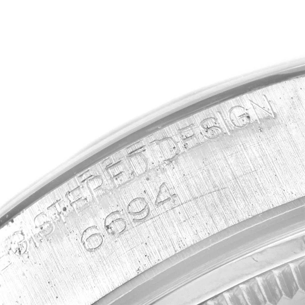 The image shows a close-up of the engraved inner bezel of the Rolex Vintage Collection 6694 Men
s Stainless Steel Silver Dial 6694 Men
s Stainless Steel Silver Dial model.