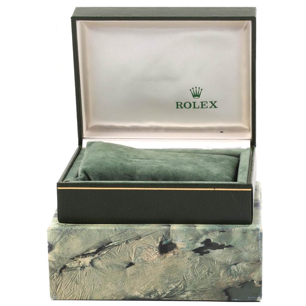 This image shows an open Rolex Vintage Collection 6694 Men
s Stainless Steel Silver Dial 6694 Men
s Stainless Steel Silver Dial watch box with a green cushion inside, viewed from the front.