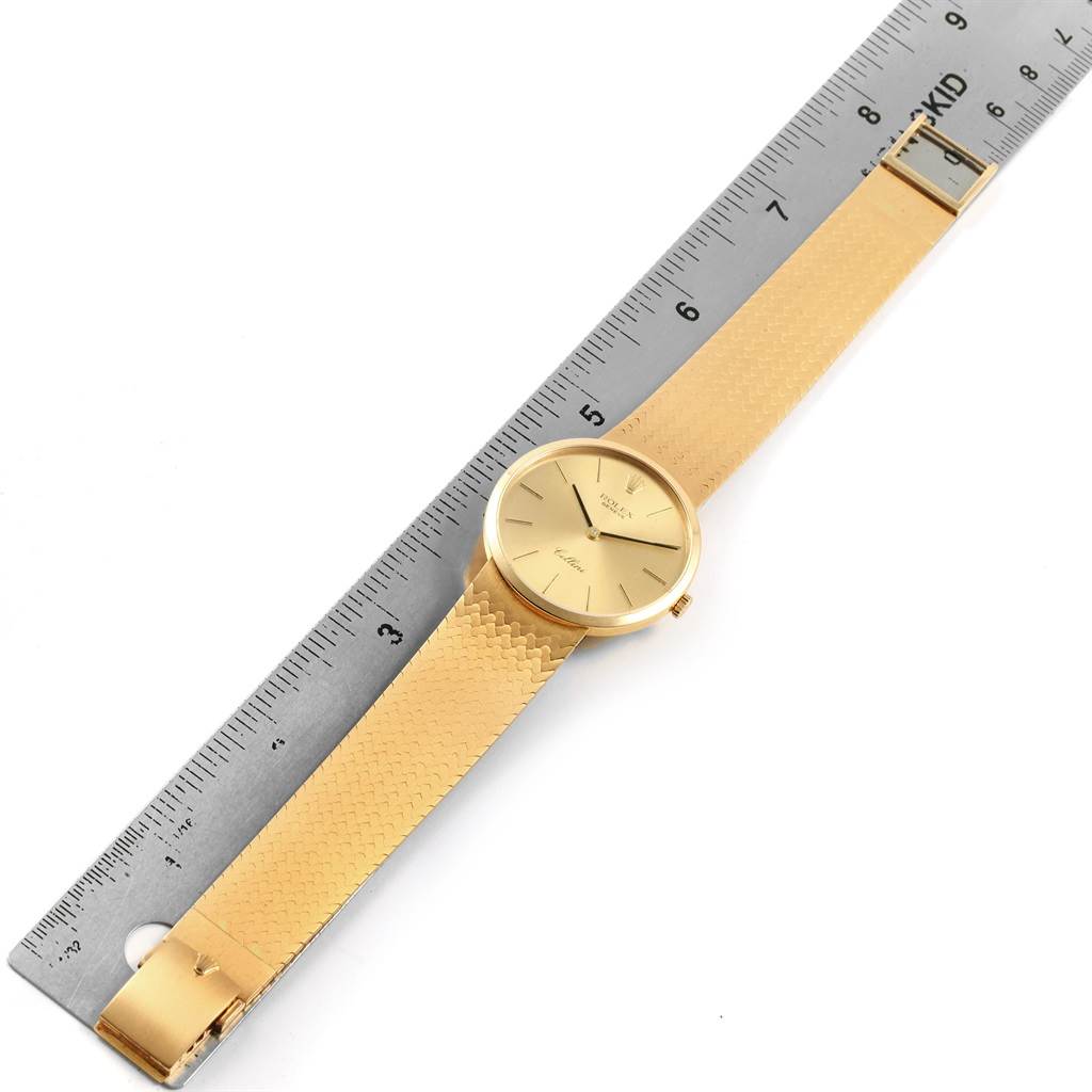 The image shows a top-down view of a gold Rolex Vintage Collection 4309 Men
s Yellow Gold Champagne Dial 4309 Men
s Yellow Gold Champagne Dial watch positioned next to a ruler for scale.