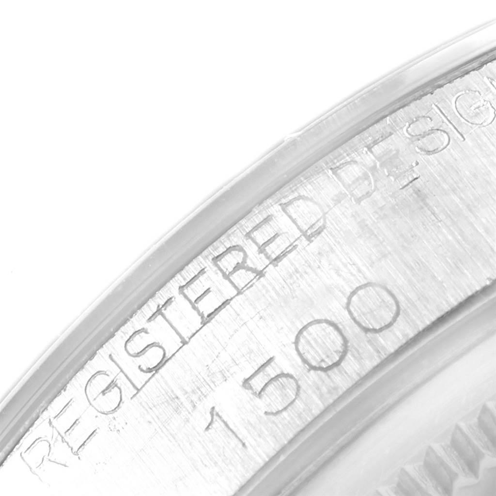 This close-up image shows the bezel with engraved text and part of the casing of a Rolex Vintage Collection 1500 Men
s Stainless Steel Silver Dial 1500 Men
s Stainless Steel Silver Dial model watch.