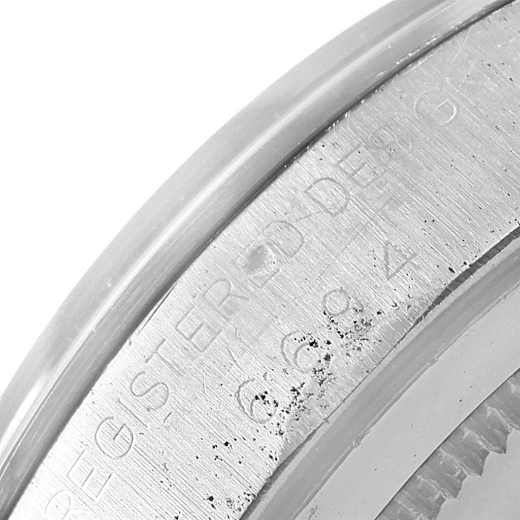 The image shows a close-up of the engraved bezel edge on a Vintage Collection Rolex watch.