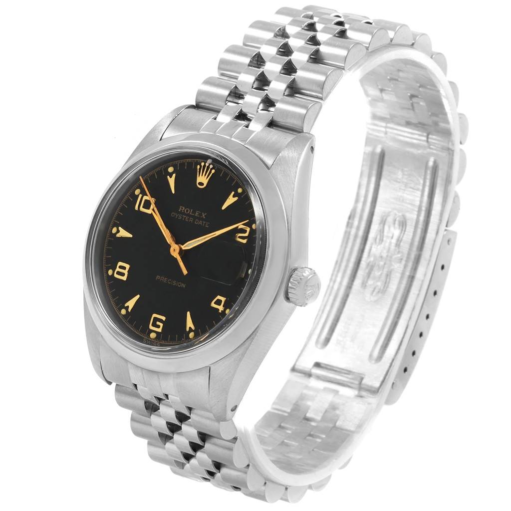 The image shows a Rolex Vintage Collection 6694 Men
s Stainless Steel Black Dial 6694 Men
s Stainless Steel Black Dial watch from an angled top view, showcasing the black dial, gold markers, and bracelet.