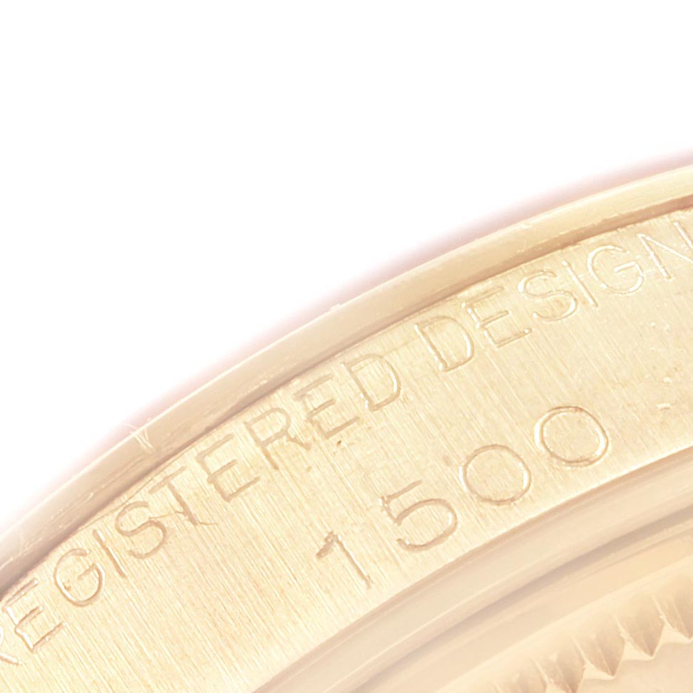 The image shows a close-up of the engraved inner bezel of the Rolex Vintage Collection 1500 Men
s Yellow Gold Champagne Dial 1500 Men
s Yellow Gold Champagne Dial model with text "REGISTERED DESIGN 1500."