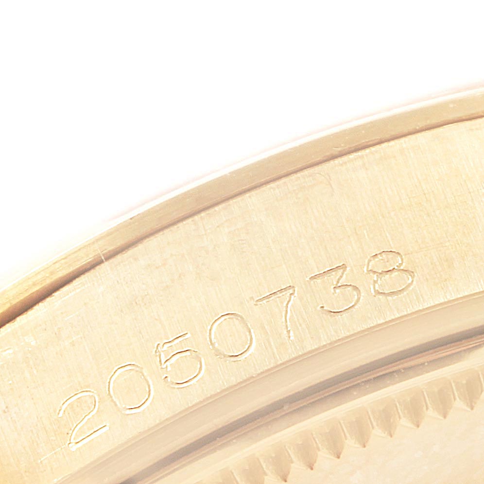 This close-up image shows the engraved serial number on the edge of the bezel of a Vintage Collection model by Rolex.
