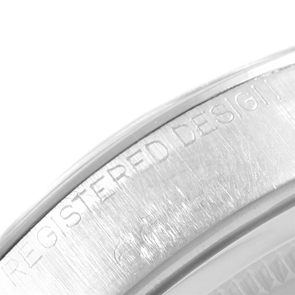 The image shows a close-up of the side of a Vintage Collection Rolex watch, highlighting the "REGISTERED DESIGN" engraving.