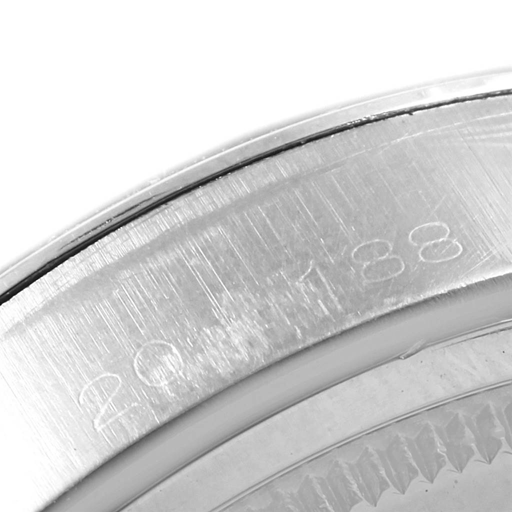 This is a close-up of the case edge for a Vintage Collection model by Rolex showing partial engraving.
