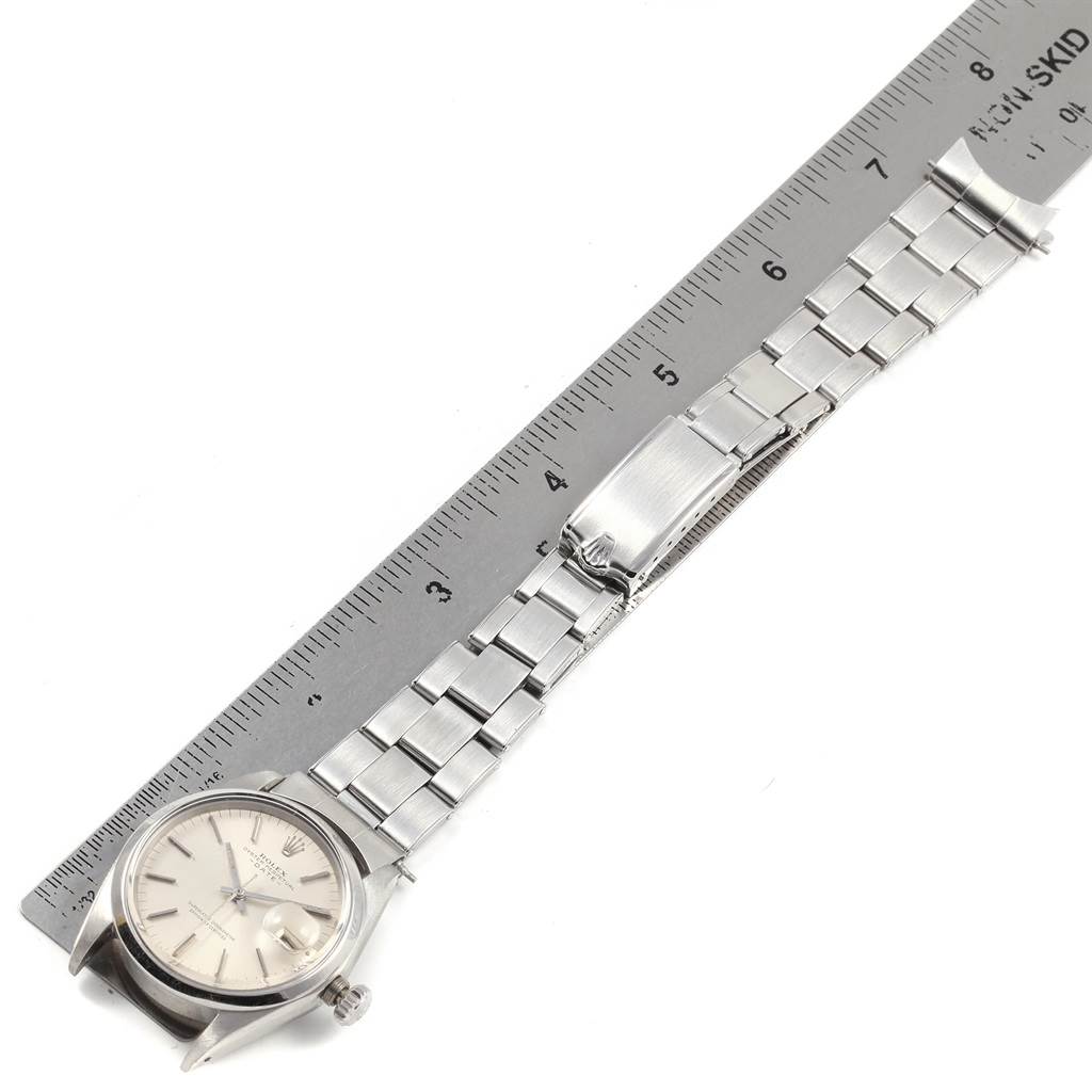 The image shows a side angle view of the Rolex Vintage Collection 1500 Men's Stainless Steel Silver Dial 1500 Men's Stainless Steel Silver Dial watch, including its face, bracelet, and deployment clasp.