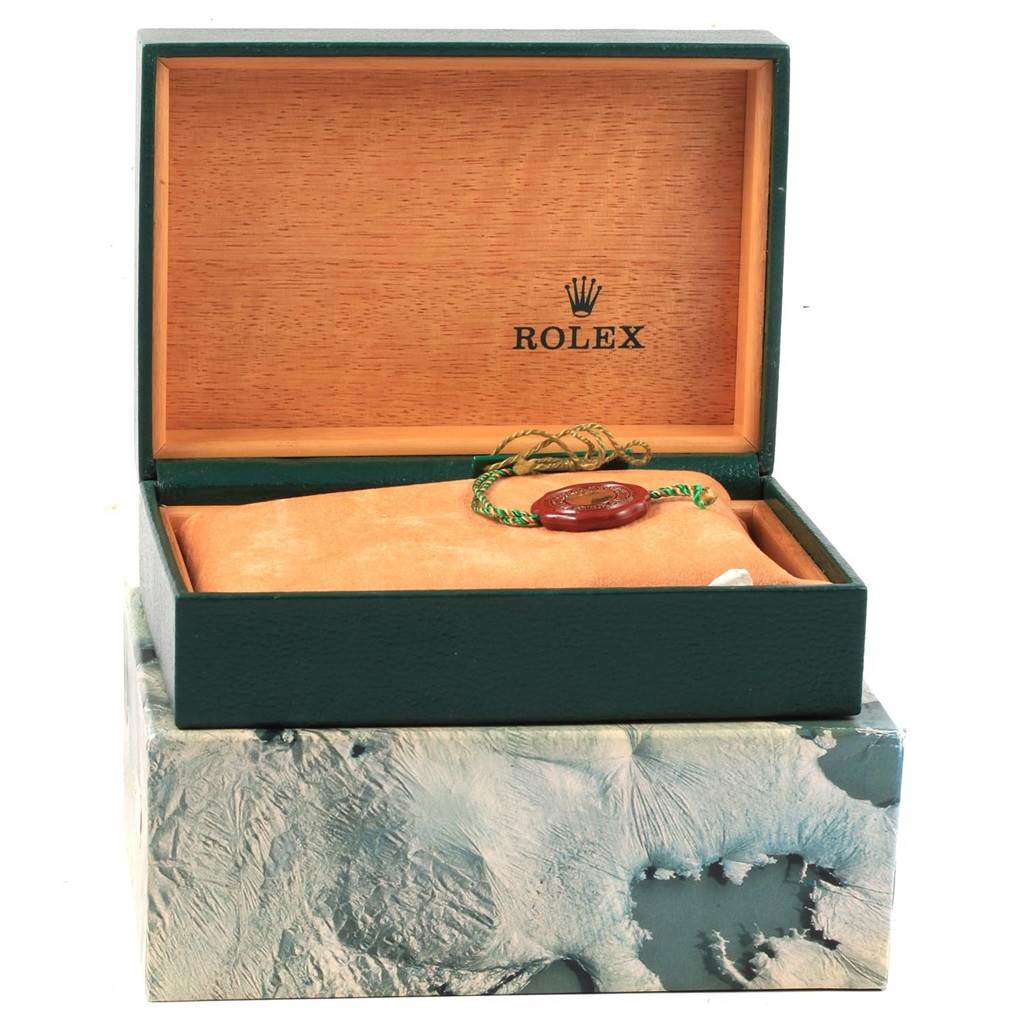 This image shows an open Rolex Vintage Collection 1500 Men's Stainless Steel Silver Dial 1500 Men's Stainless Steel Silver Dial watch box with a green seal on the cushion inside.