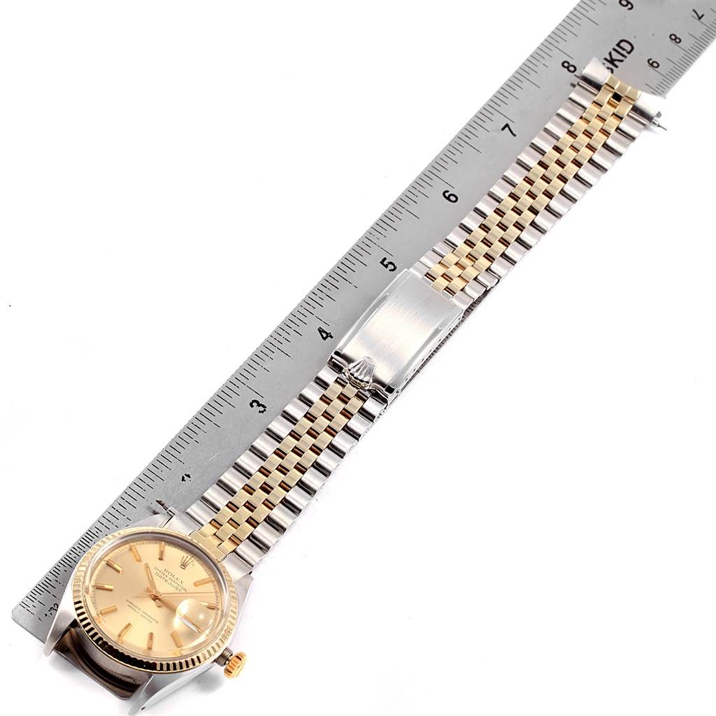 The image shows a Vintage Collection Rolex watch placed horizontally beside a ruler, highlighting the bracelet and dial.