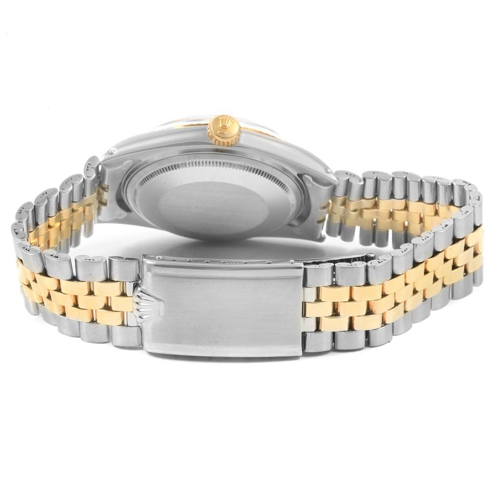 The image shows the back view of a Rolex Vintage Collection 1601 Men
s Steel and Gold (two tone) Champagne Dial 1601 Men
s Steel and Gold (two tone) Champagne Dial watch featuring its clasp, bracelet, crown, and case back.