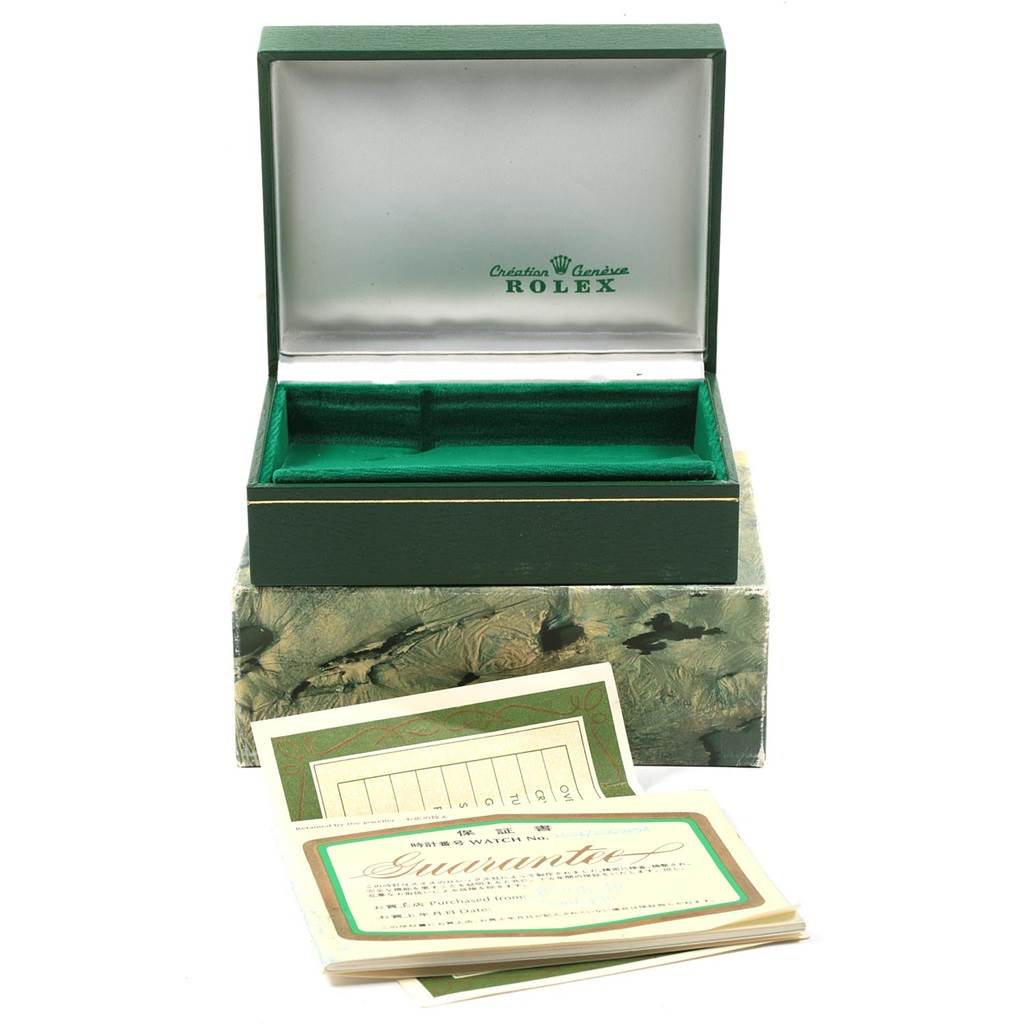 The image shows an open green box and guarantee papers for a Rolex Vintage Collection 1601 Men
s Steel and Gold (two tone) Champagne Dial 1601 Men
s Steel and Gold (two tone) Champagne Dial model.