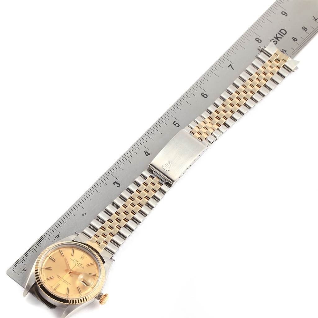 The image shows a Rolex Vintage Collection 1601 Men's Steel and Gold (two tone) Champagne Dial 1601 Men's Steel and Gold (two tone) Champagne Dial watch laid flat, with the face, bezel, crown, and bracelet all visible alongside a ruler for scale.