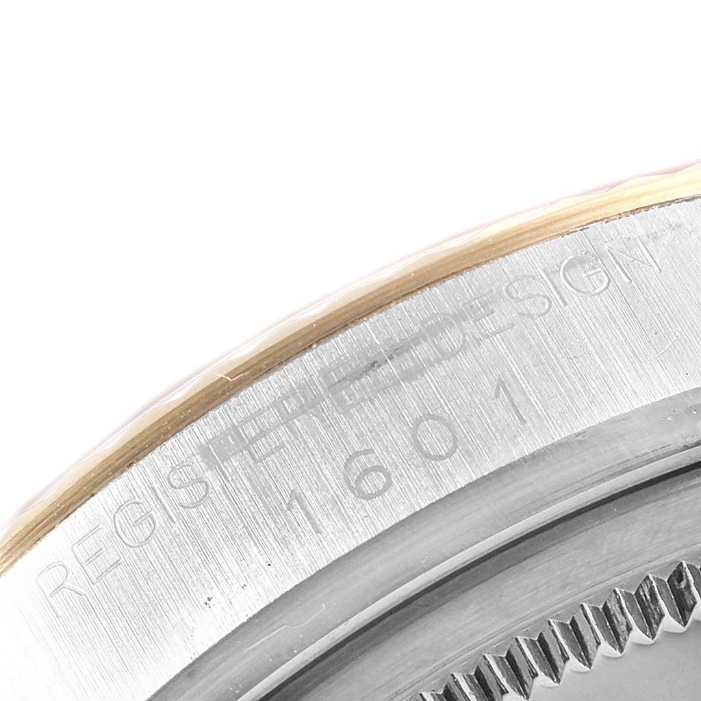 This image shows a close-up of the serial number and part of the bezel of a Rolex Vintage Collection 1601 Men's Steel and Gold (two tone) Champagne Dial 1601 Men's Steel and Gold (two tone) Champagne Dial model.