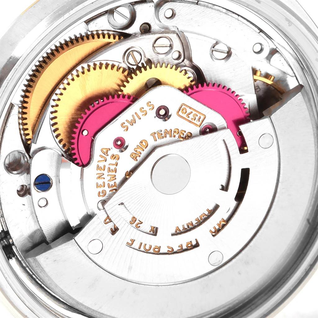 The image shows the internal mechanism of a Vintage Collection Rolex watch, highlighting gears and intricate parts.