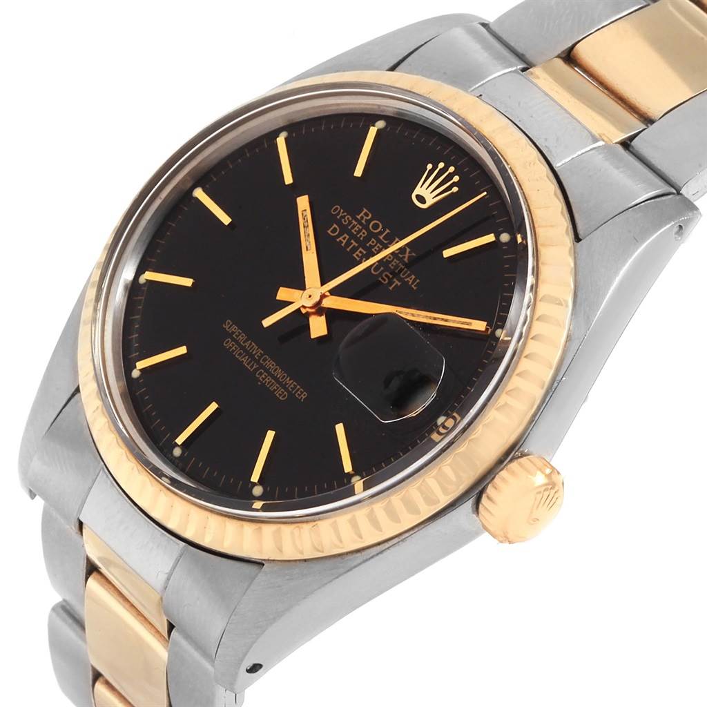 The Rolex Vintage Collection 1601 Men's Steel and Gold (two tone) Black Dial 1601 Men's Steel and Gold (two tone) Black Dial watch is shown at a slight angle, highlighting its black dial, gold bezel, and part of the band and crown.