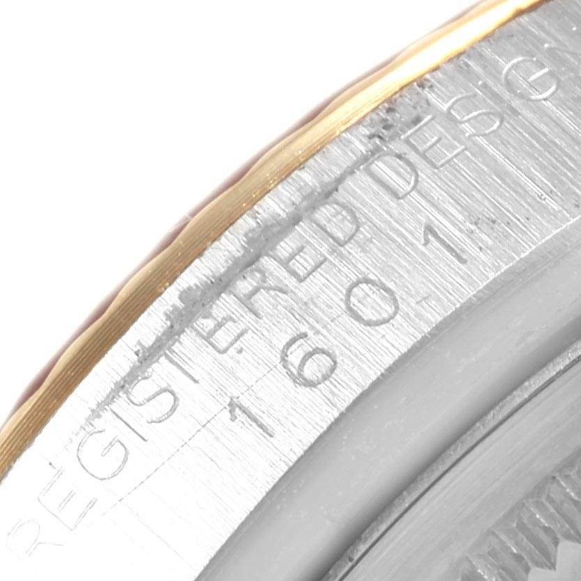 The image shows an extreme close-up of the engraved bezel edge for a Rolex Vintage Collection 1601 Men's Steel and Gold (two tone) Black Dial 1601 Men's Steel and Gold (two tone) Black Dial watch.