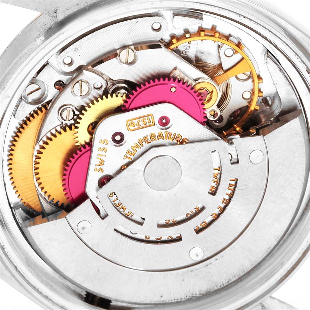 The image shows the internal mechanism of the Rolex Vintage Collection 1601 Men's Steel and Gold (two tone) Black Dial 1601 Men's Steel and Gold (two tone) Black Dial model at a close-up angle, highlighting its gears and components.