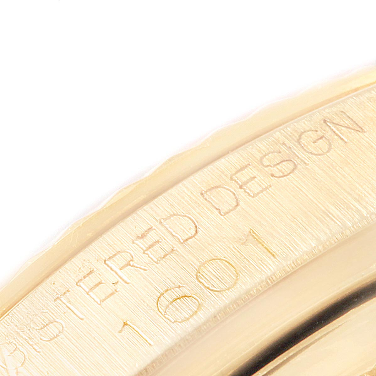 The image shows a close-up of the bezel and part of the engraved design of the Vintage Collection Rolex model 1601 watch.