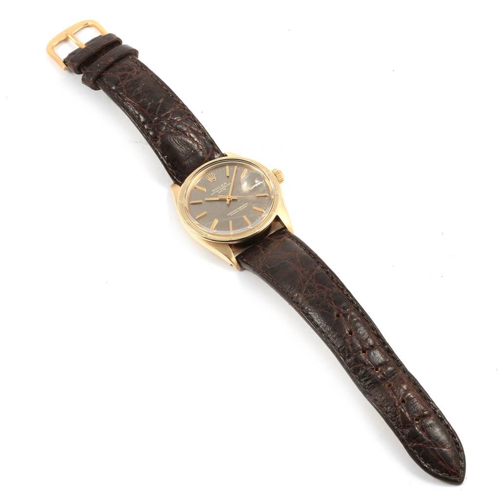 The image shows a Rolex Vintage Collection 1501 Men's Yellow Gold Brown Dial 1501 Men's Yellow Gold Brown Dial watch with a gold case and a brown leather strap, viewed from an overhead angle.