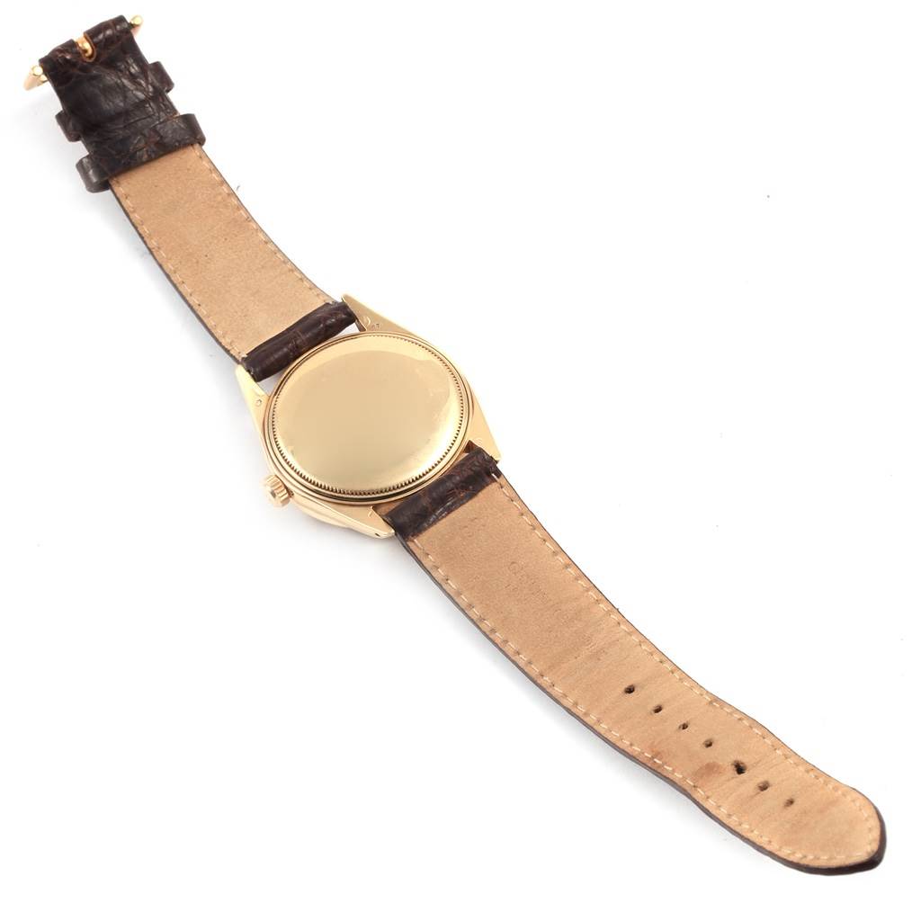 This image shows the back of a Rolex Vintage Collection 1501 Men's Yellow Gold Brown Dial 1501 Men's Yellow Gold Brown Dial watch with its leather strap fully extended.