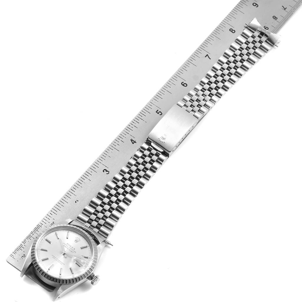 This image shows a top view of a Rolex Vintage Collection 16030 Men's Stainless Steel Silver Dial 16030 Men's Stainless Steel Silver Dial watch with its bracelet fully extended alongside a ruler.