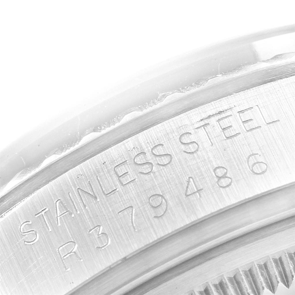This image shows the engraved serial number on the stainless steel casing of a Vintage Collection model by Rolex.