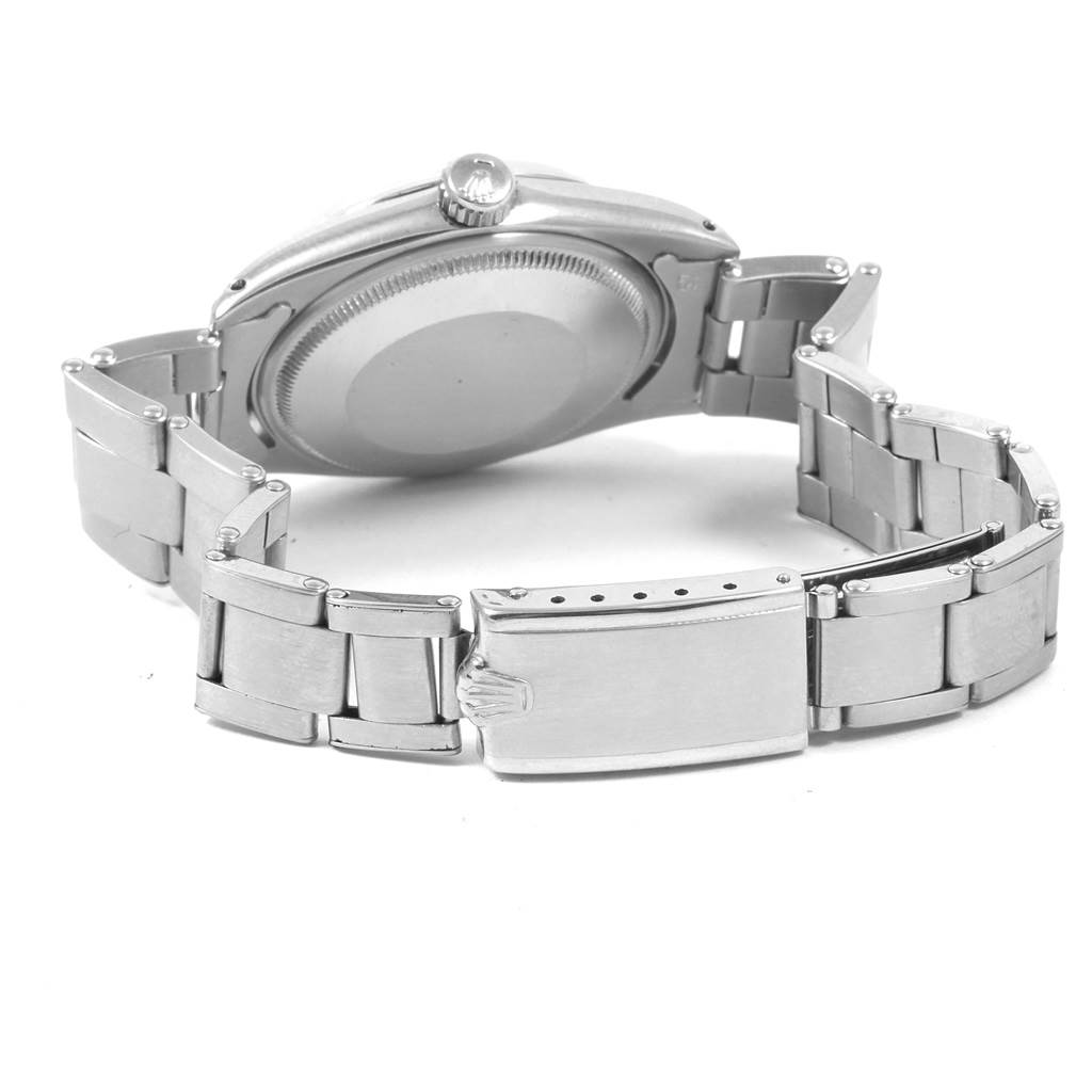 The image shows the back case and bracelet of a Vintage Collection Rolex watch from a rear angle.