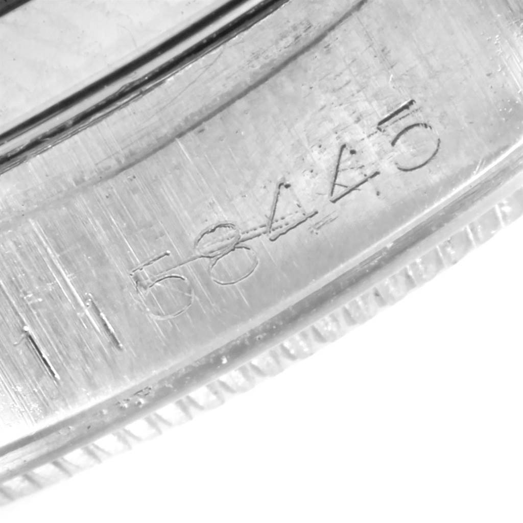 The image shows an angled close-up of the serial number and the ridged bezel of the Rolex Vintage Collection 1500 Stainless Steel Silver Dial 1500 Stainless Steel Silver Dial model.
