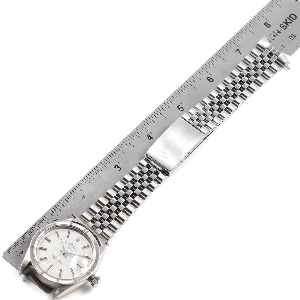 The Rolex Vintage Collection 1501 Men's Stainless Steel Silver Dial 1501 Men's Stainless Steel Silver Dial model watch is shown at a top-down angle, displaying its face, bracelet, and clasp alongside a ruler for scale.