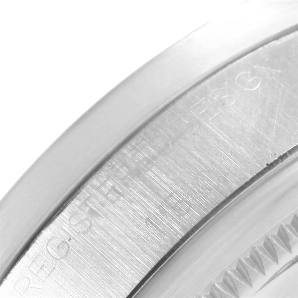 The image shows a close-up of the engraved side and bezeled edge of a Vintage Collection model by Rolex.