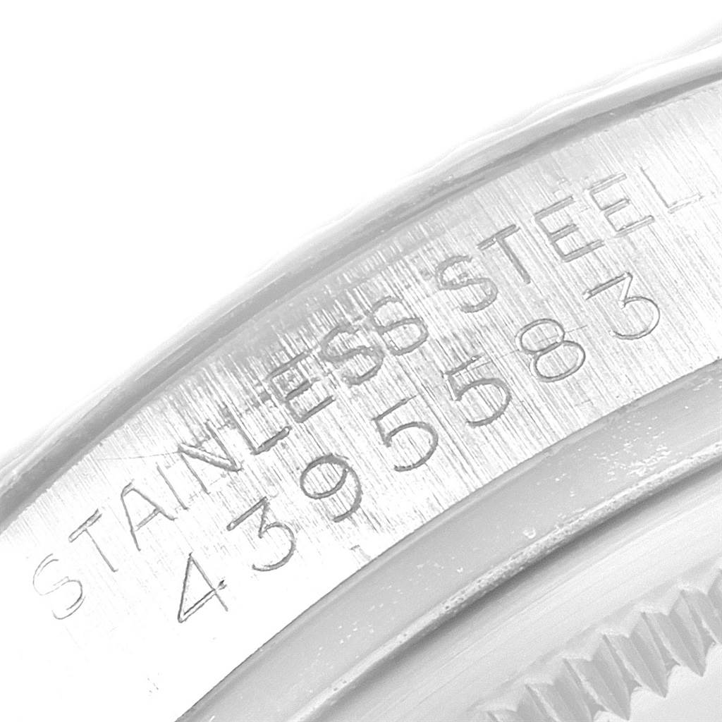 This image shows a detailed close-up of the engraved serial number on the stainless steel of a Vintage Collection Rolex watch.