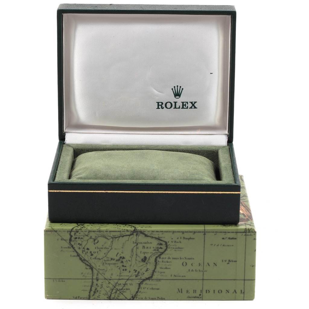 The image shows an open Rolex Vintage Collection 1500 Men
s Yellow Gold Silver Dial 1500 Men
s Yellow Gold Silver Dial watch box, revealing a green cushion inside.