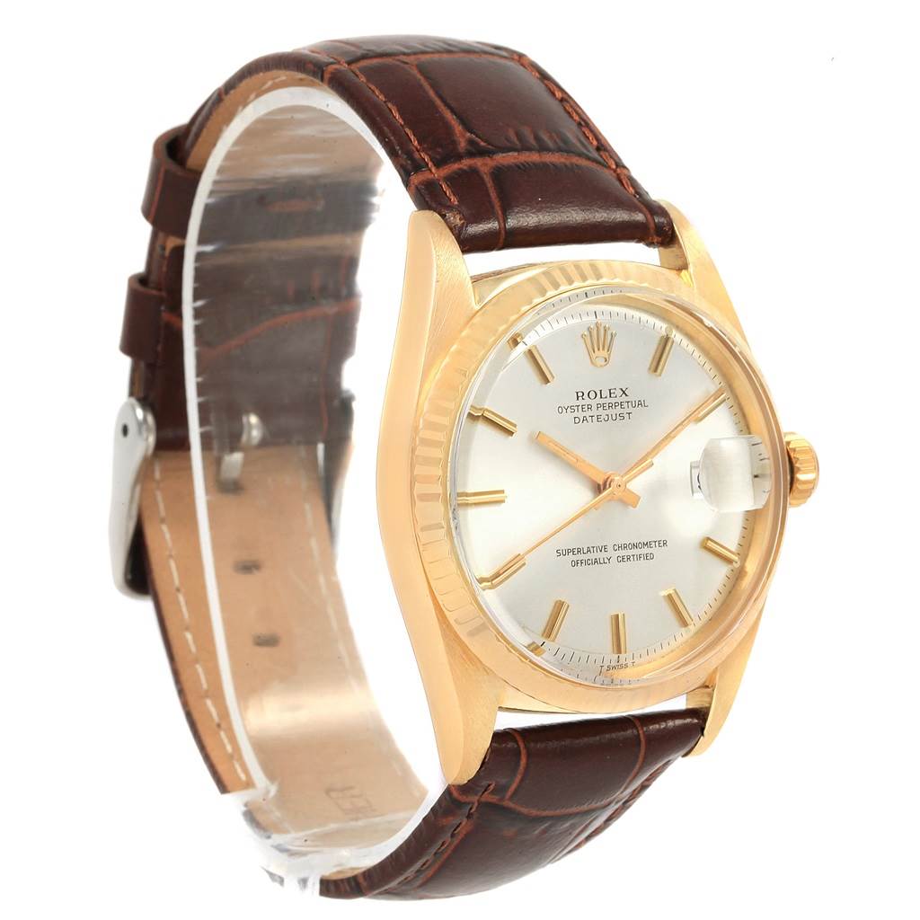The Rolex Vintage Collection 1601 Men
s Yellow Gold Silver Dial 1601 Men
s Yellow Gold Silver Dial watch is shown at a slight angle, displaying the face, bezel, crown, and brown leather strap.