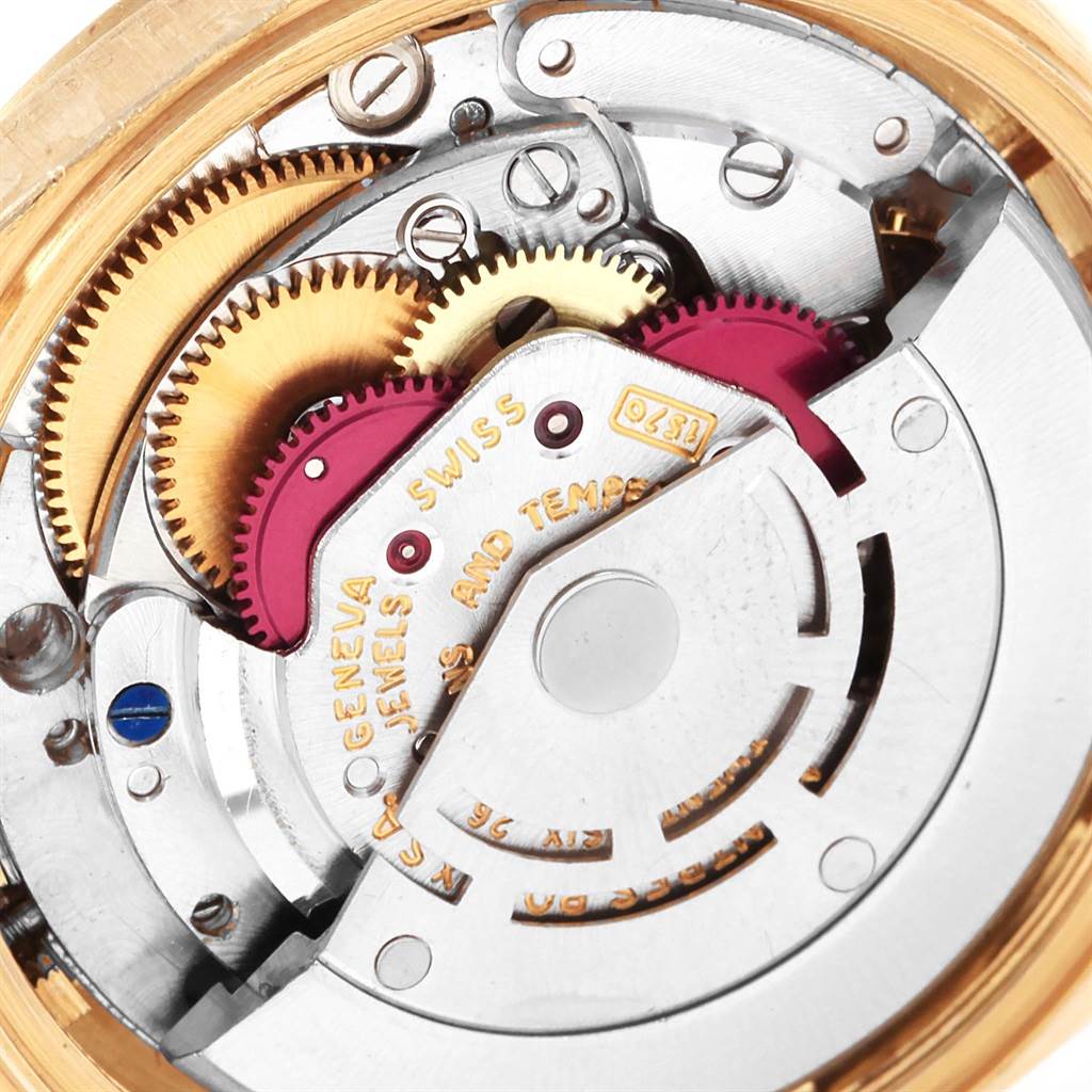 The image shows a close-up of the inner movement and gears of a Vintage Collection Rolex watch.