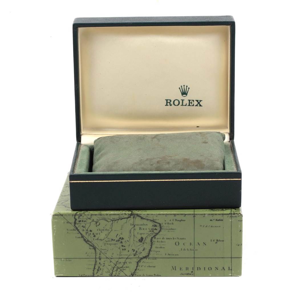 This image shows an open box for a Vintage Collection Rolex watch, featuring the inner cushion and outer box with a map design.
