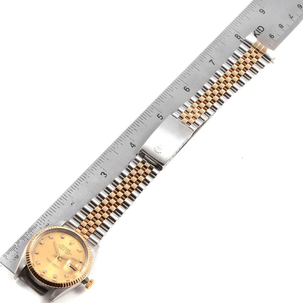 The image shows a Rolex Vintage Collection 16013 Men's Stainless Steel Champagne Dial 16013 Men's Stainless Steel Champagne Dial watch from a top-down angle, highlighting its face, crown, and bracelet with a ruler for measurement.