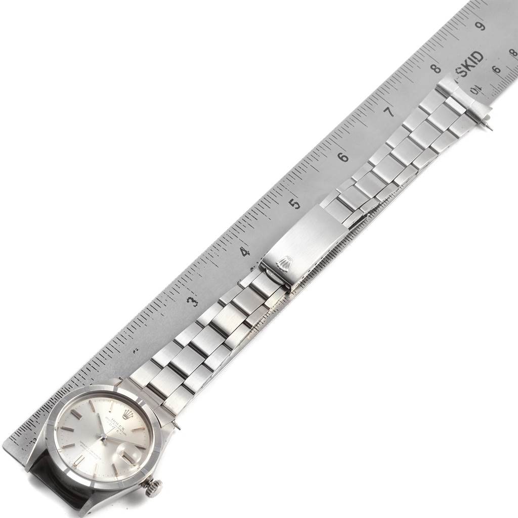 The image shows the Rolex Vintage Collection 1501 Men's Stainless Steel Silver Dial 1501 Men's Stainless Steel Silver Dial watch placed next to a ruler, highlighting the watch's face, band, and clasp.