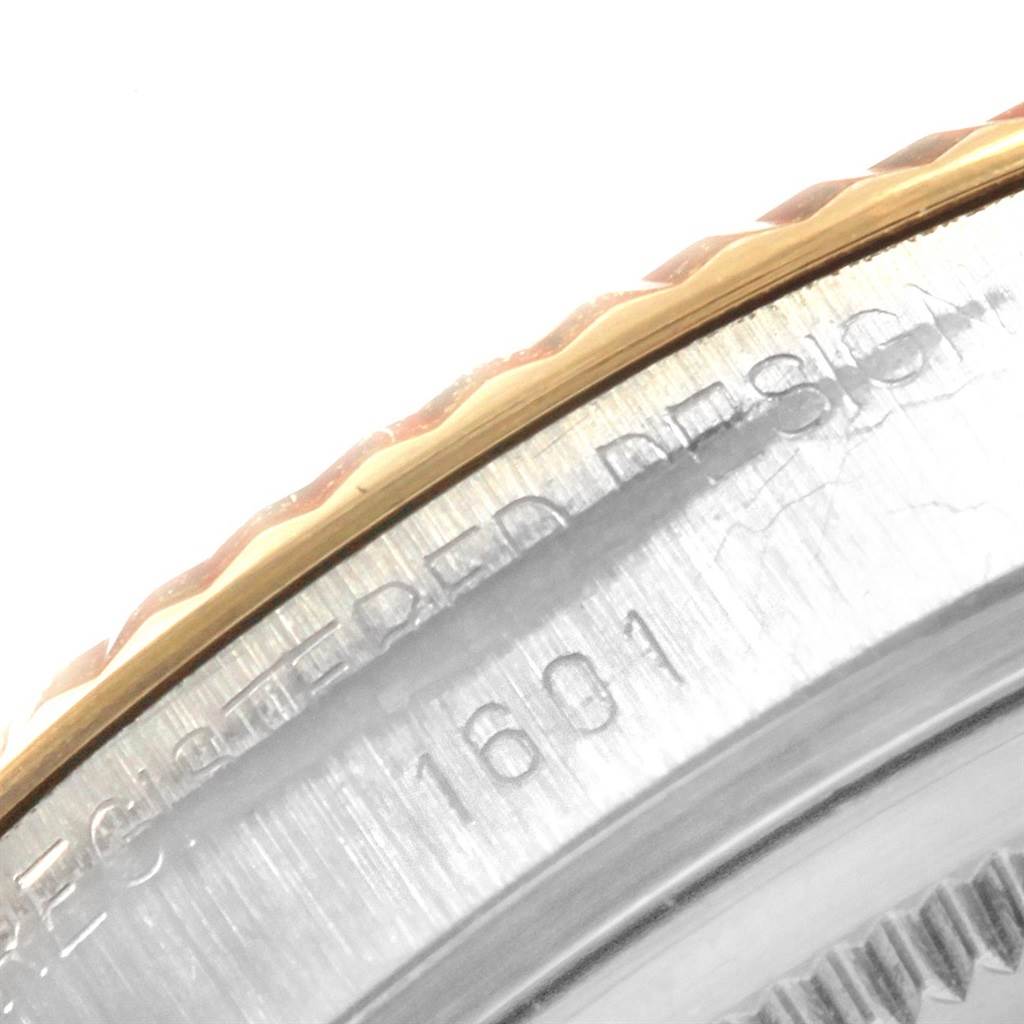 This close-up image shows the side engraving and part of the bezel of the Rolex Vintage Collection 1601 Men's Steel and Gold (two tone) Grey Dial 1601 Men's Steel and Gold (two tone) Grey Dial model 1601.
