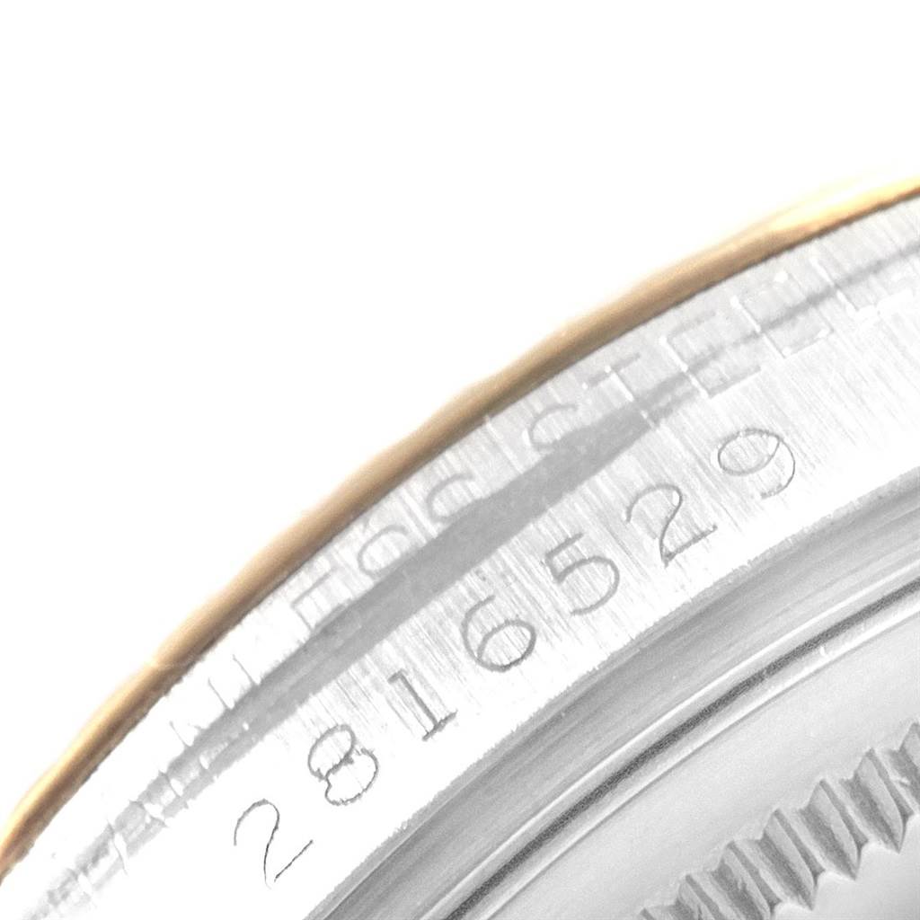 This image shows a close-up of the serial number and part of the bezel on a Vintage Collection Rolex watch.