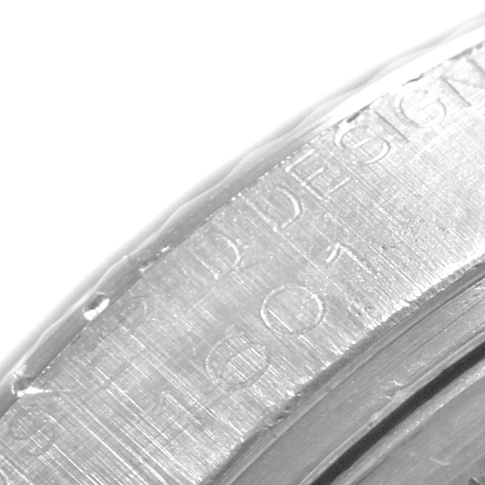 This is a close-up of the edge of the casing, showing engraved text on the Rolex Vintage Collection 1601 Men's Stainless Steel Grey Dial 1601 Men's Stainless Steel Grey Dial watch.