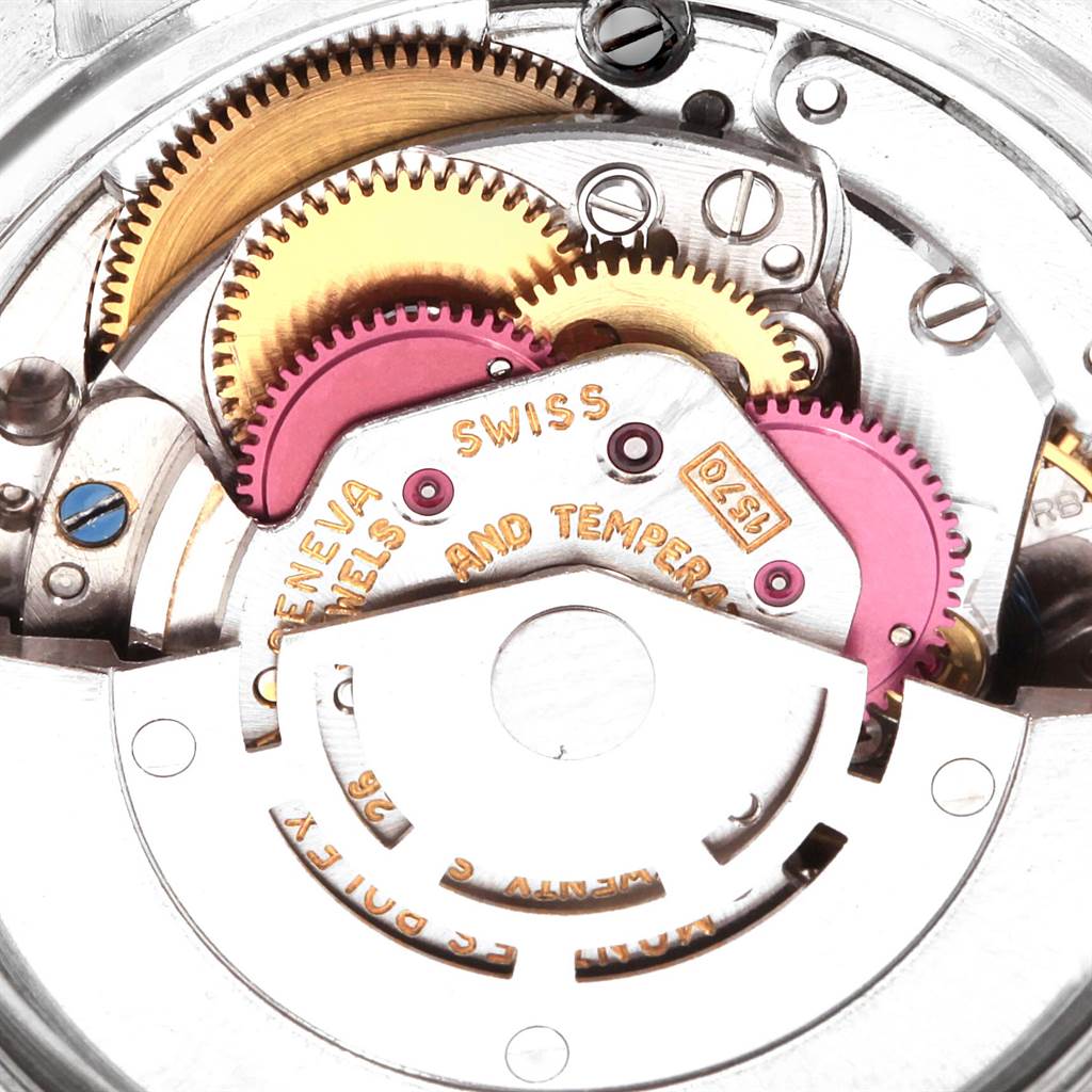 The image displays the intricate internal mechanical movement of a Rolex Vintage Collection 1601 Men's Stainless Steel Grey Dial 1601 Men's Stainless Steel Grey Dial watch, focusing on its gears and components.