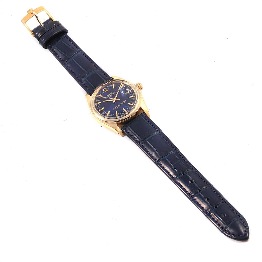 The image shows a bird
s-eye view of a Vintage Collection Rolex watch, highlighting its blue leather strap and gold case.