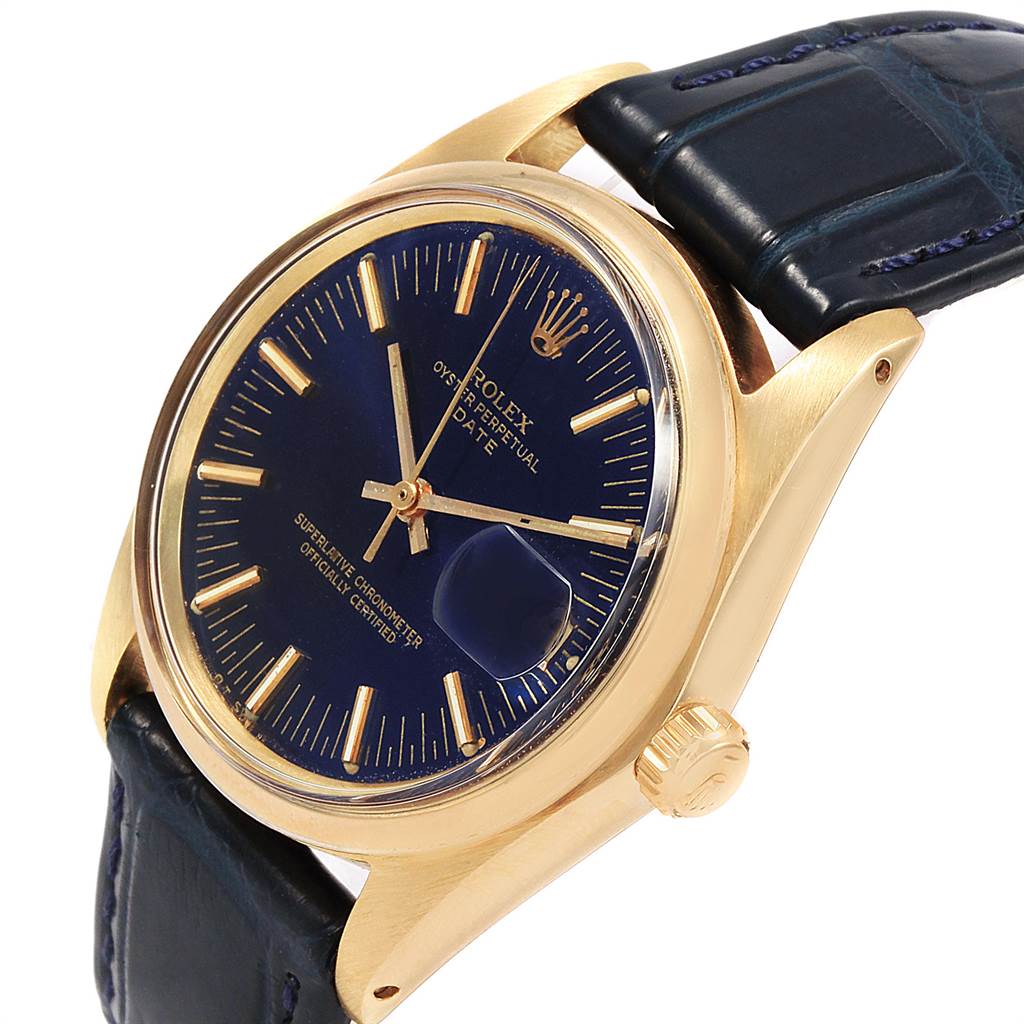 The image shows a side angle of a Rolex Vintage Collection 1503 Men
s Yellow Gold Blue Dial 1503 Men
s Yellow Gold Blue Dial watch, displaying its gold case, blue dial, and leather strap.