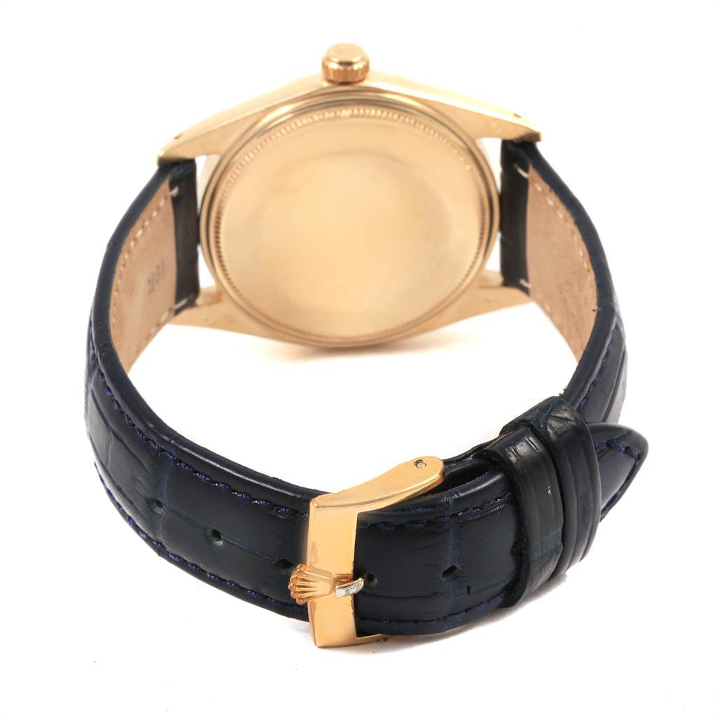 The image shows the back view of the Rolex Vintage Collection 1503 Men
s Yellow Gold Blue Dial 1503 Men
s Yellow Gold Blue Dial model, featuring its case and leather strap with a visible buckle.